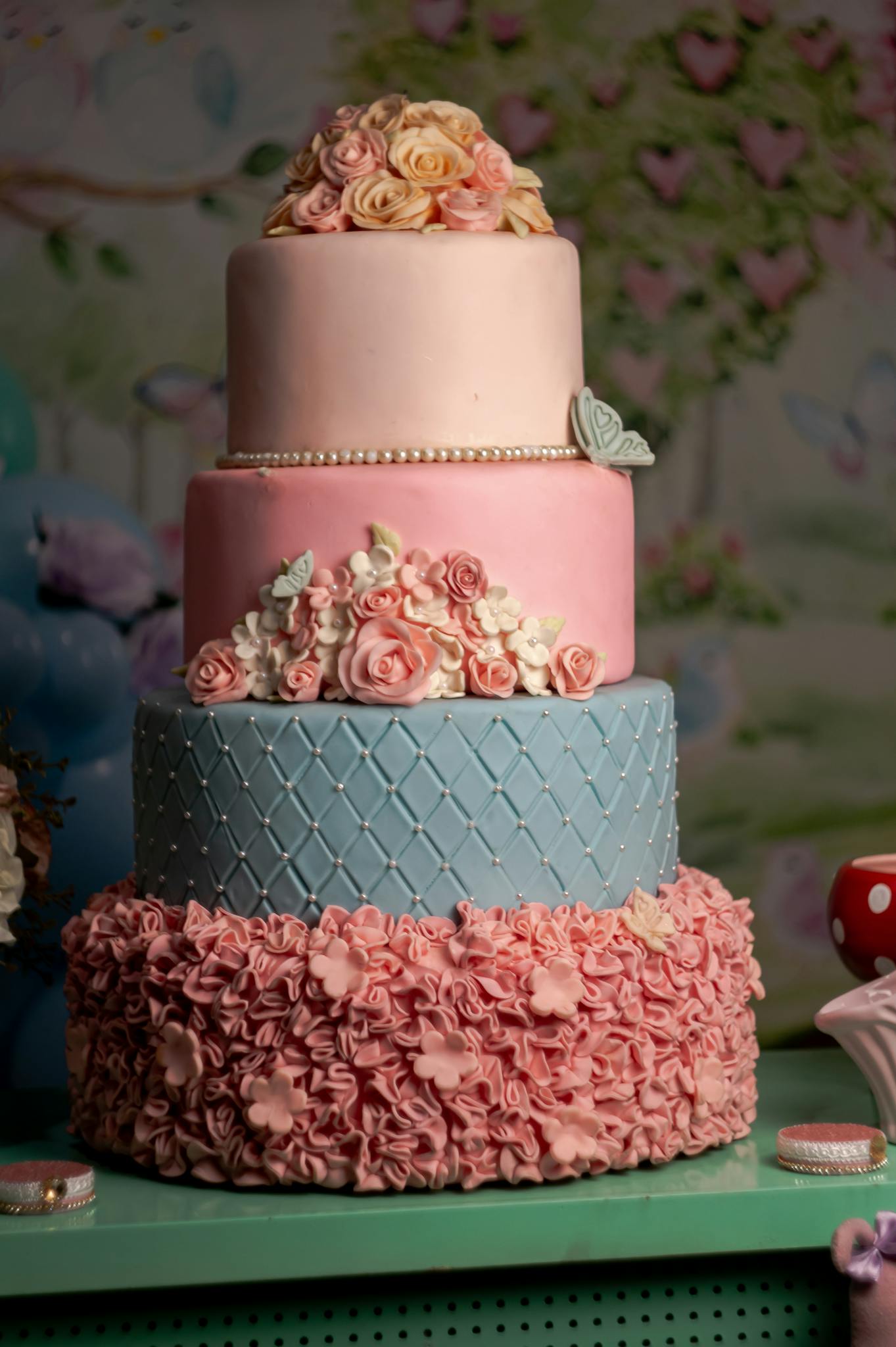 An exquisite three-tier wedding cake adorned with pastel flowers and intricate designs, perfect for special occasions.
